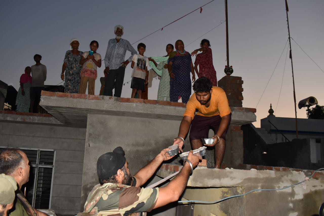 In flood affected areas, relief workers delivered food and drink packets to people's homes